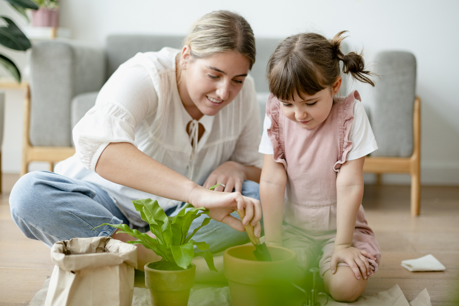 Female helper with child potting plant